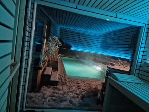 a view of a swimming pool through a window at Bella Flocon appartements min 2 Nights Special weekly and monthly prices in Savièse