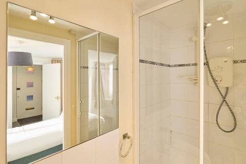 a bathroom with a shower and a mirror at Host & Stay - King's Corner in Canterbury