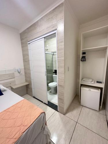 a bedroom with a bathroom with a shower and a toilet at Pousada São Luiz in Aracaju