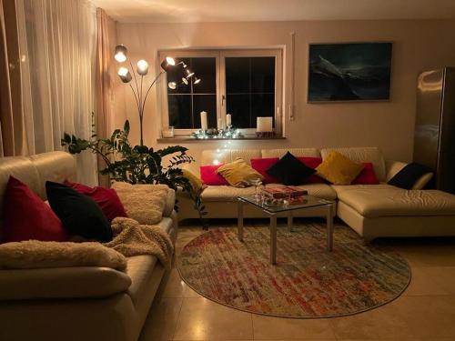 a living room with a couch and a table at See- und Bergblick in Bestlage am Tegernsee in Tegernsee