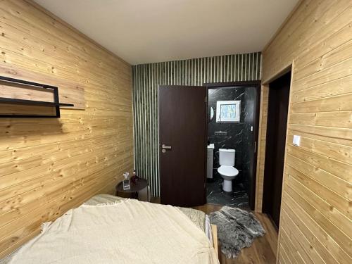 a bedroom with a bed and a toilet at Tiny house v Moravském Berouně in Moravský Beroun