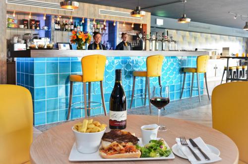 a table with a plate of food and a bottle of wine at Nox Hotel Galway in Galway