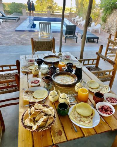 a wooden table with food on top of it at Chill House surf camp in Sidi Kaouki