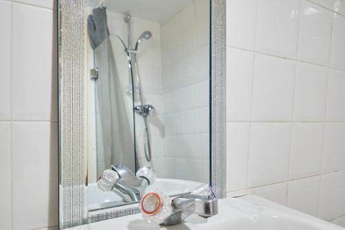 a bathroom sink with a shower in a mirror at Host & Stay - Bingley Court in Canterbury
