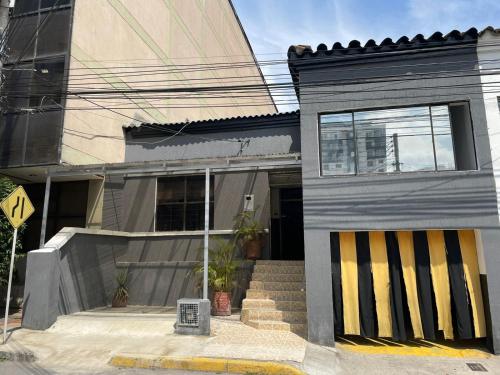 a small house with a yellow and black door at Residencia del Oriente in Bucaramanga