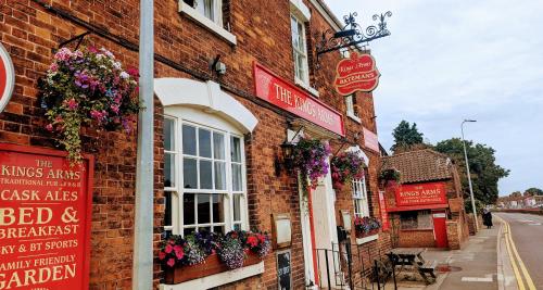 a brick building with flowers on the side of it at The King's Arms in Boston