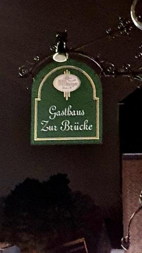 a green and white sign on the side of a building at Hotel zur Brücke in Herzogenrath