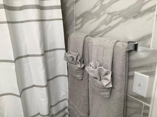 a bathroom with towels hanging on a curtain at Breathless Vista “4” in St Thomas