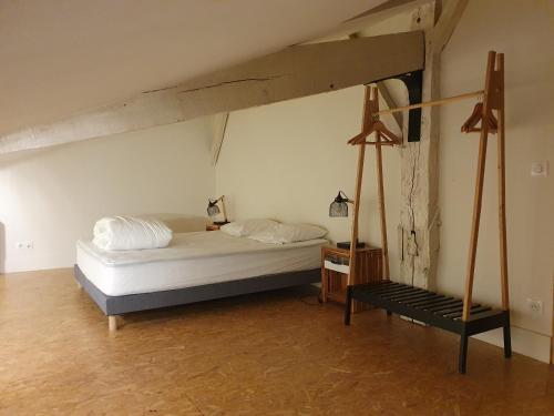a bedroom with a bed and a bench in it at exceptionnel loft style industriel tout équipé 15 personnes avec piscine et jacuzzi in Villebramar