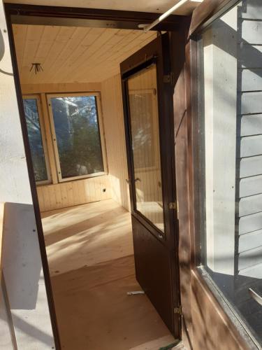 a door to the inside of a tiny house at Garden Chamber in Rovaniemi
