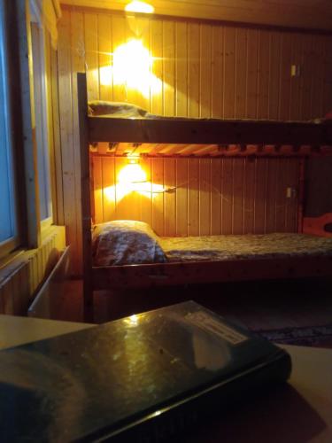 a room with two bunk beds and a table at Garden Chamber in Rovaniemi