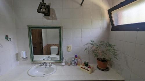 a bathroom with a sink and a mirror at Loren House in Ciudad Lujan de Cuyo