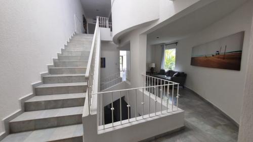 a staircase in a home with white walls at Villas La Marina in Cancún