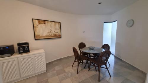 a dining room with a table and chairs at Villas La Marina in Cancún