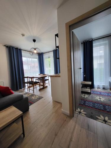 a living room with a couch and a table at Villa Olimpijska 2 - Centrum in Wisła