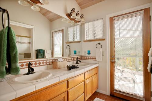 a bathroom with two sinks and a large mirror at 430 Orlando in Cambria