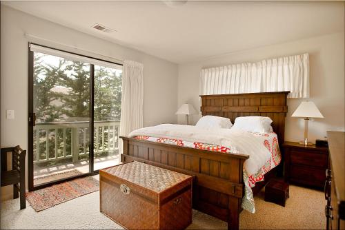 a bedroom with a large bed and a large window at 430 Orlando in Cambria