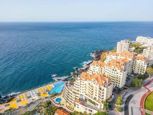 an aerial view of a resort near the ocean at Cliff in Funchal