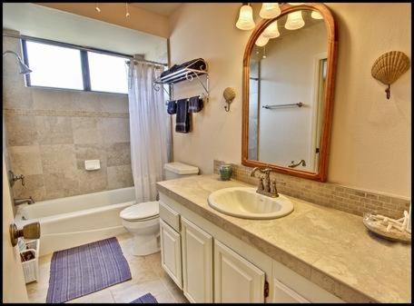 a bathroom with a sink and a toilet and a mirror at 2116 Windsor Blvd. Marine Terrace in Cambria