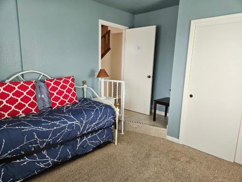 a bedroom with a bed with red pillows on it at 2116 Windsor Blvd. Marine Terrace in Cambria