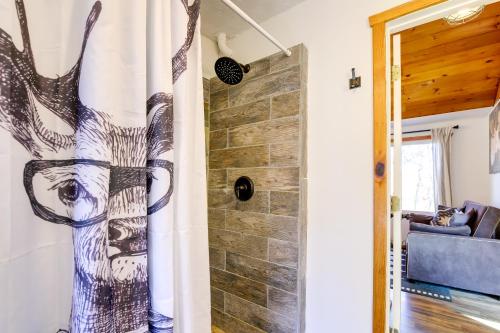 a shower in a room with a stone wall at Faith Cabin in Cosby Fire Pit and Covered Deck in Cosby