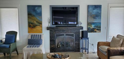 a living room with a fireplace with a tv above it at 4812 Windsor Bl. in Cambria