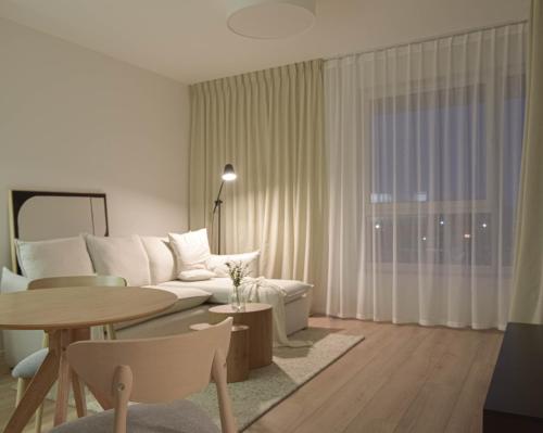 a living room with a couch and a table at JAPANDI Apartament Modlińska Żerań in Warsaw
