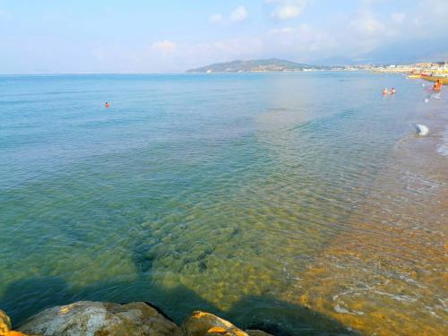a view of a beach with people swimming in the water at Casa Annalisa in Scauri
