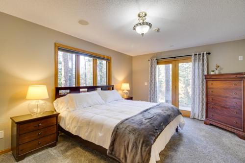 a bedroom with a bed and a dresser and a window at Peaceful Hibbing Getaway Heated Floors, Fire Pit! in Hibbing