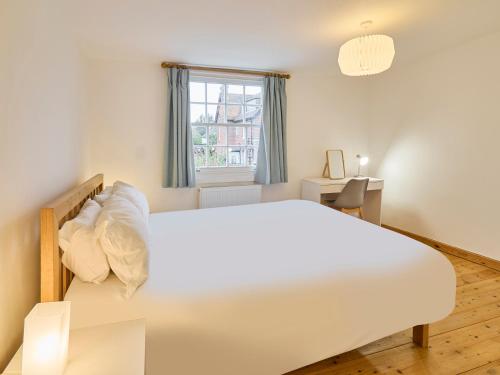 a bedroom with a large white bed and a window at Host & Stay - New Street in Canterbury