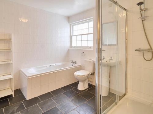 a bathroom with a tub and a toilet and a shower at Host & Stay - New Street in Canterbury