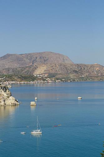 a boat sitting in the middle of a large body of water at Villa THAMI in Almirida