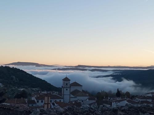 a view of a town in the clouds at Lovely Town House Casa La Senda in Grazalema
