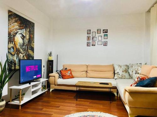 a living room with a couch and a tv at Sea View Apartment in Kadikoy in Istanbul