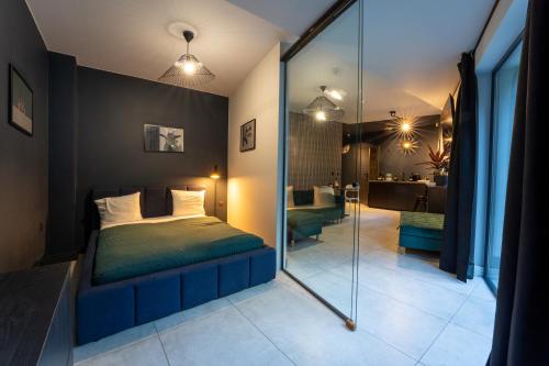 a bedroom with a bed and a glass wall at Leśna Kąpiel in Karpacz