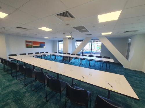 a large conference room with a long table and chairs at La Quinta by Wyndham Ellerslie Auckland in Auckland