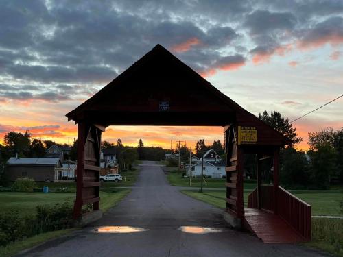 a wooden pavilion with the sunset in the background at Nature's Retreat in Latchford