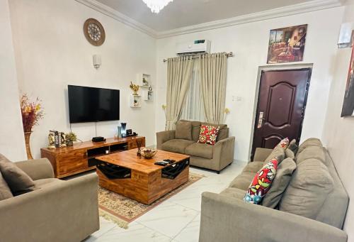 a living room with two couches and a television at Exotic 2 BR Apartment at Wuye, Abuja - Wifi,Netflix in Abuja