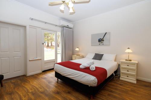 a bedroom with a bed with a teddy bear on it at BIG4 Cape Jervis Accommodation & Caravan Park in Cape Jervis