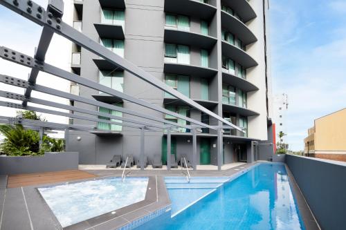 a swimming pool in front of a building at Oaks Brisbane on Felix Suites in Brisbane