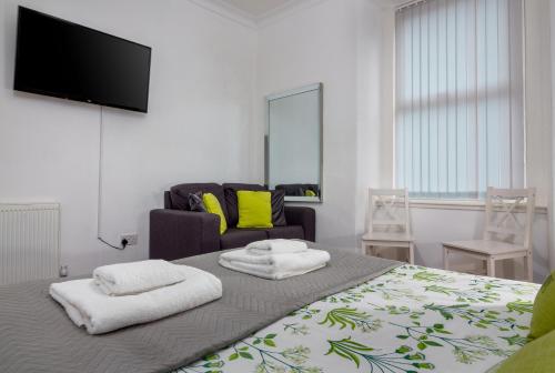 a bedroom with a bed with two towels on it at Tranquil Place in Dundee near Docks in Dundee