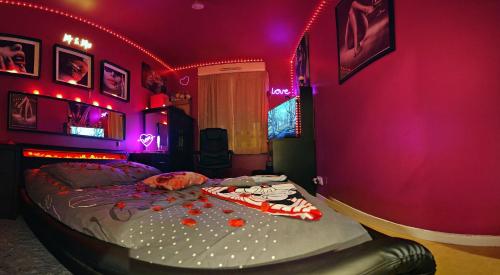 a bedroom with a bed with purple lights on it at Love Room Chambre Privée Chez Habitant proche gare rer 5 minute à pied in Aulnay-sous-Bois
