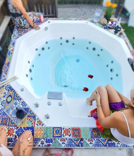 a group of people sitting around a swimming pool at Casa Hala LOFT & SPA LUXURY in León