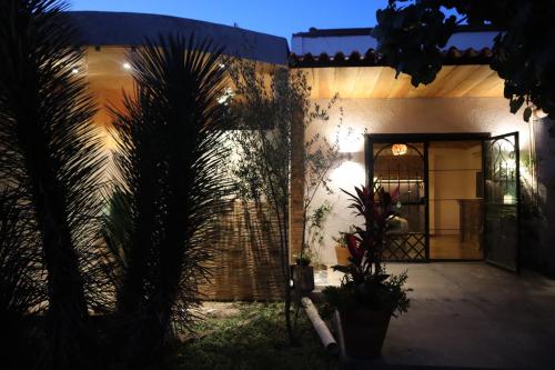 a house with palm trees in front of a door at Casa Hala LOFT & SPA LUXURY in León