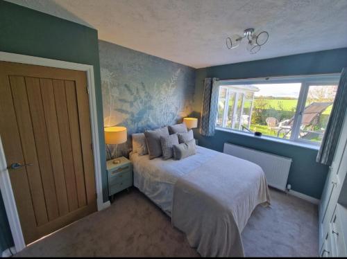 a bedroom with a bed and a window at Shirley's Place in Boston Spa