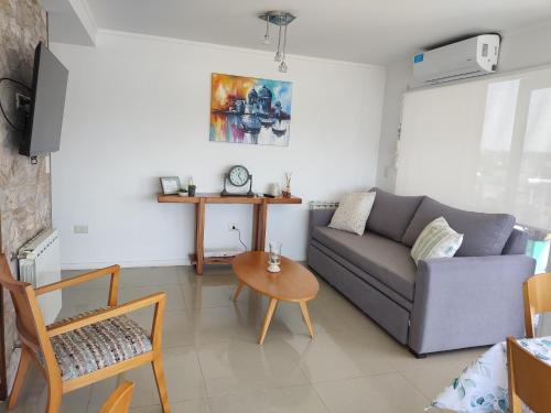 a living room with a couch and a table at Edificio Juana del Mar in Mar del Plata