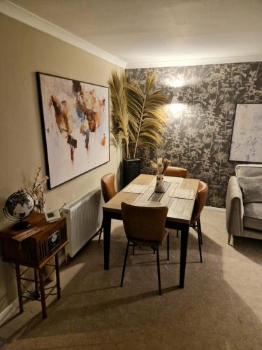 a dining room with a table and chairs and a couch at Shirley's Place in Boston Spa