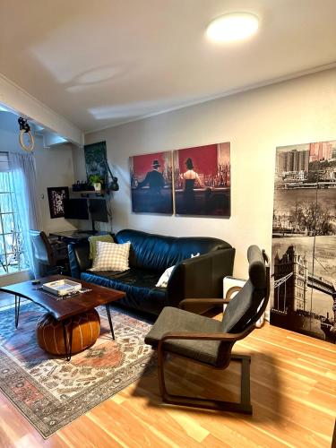 a living room with a couch and a table at HiFi Sound & Comfort - Uptown Dallas / 2-story loft in Dallas