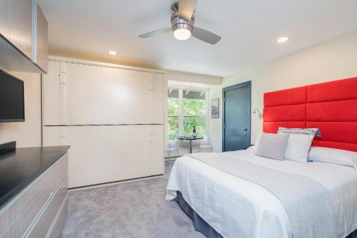 a bedroom with a large bed and a red headboard at Mountainside Inn 419/421 by Alpine Lodging Telluride in Telluride
