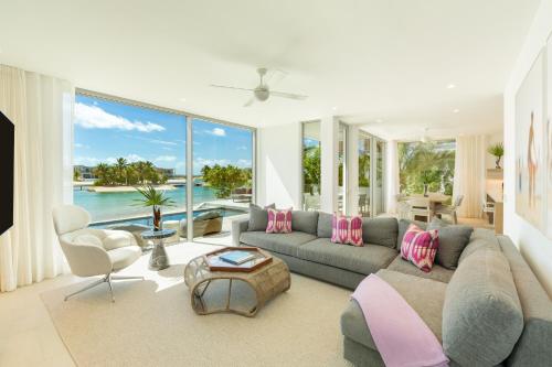 a living room with a couch and a table at South Bank in Long Bay Hills